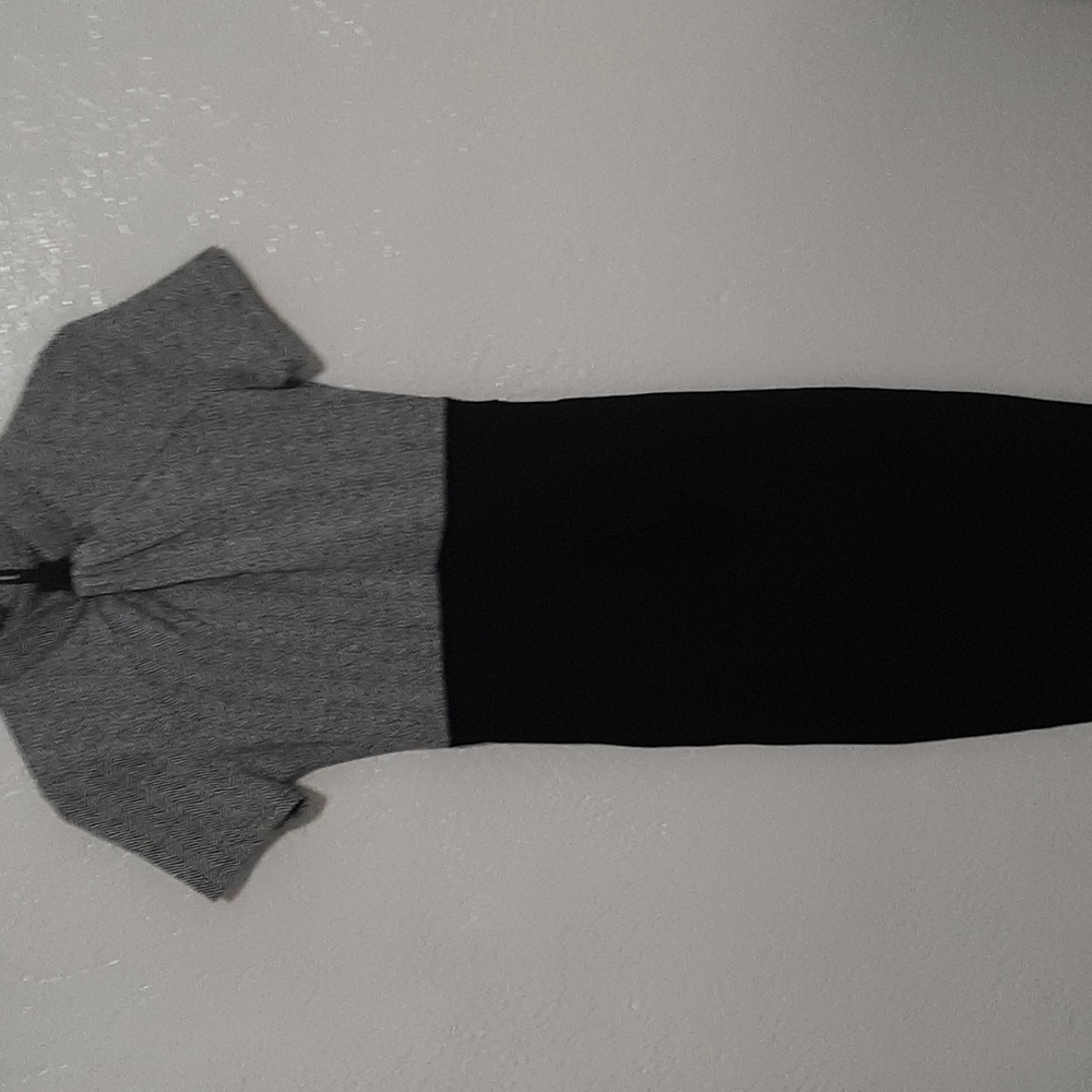 Dress, top half is zig zag patterned black and white, bottom half is plain black